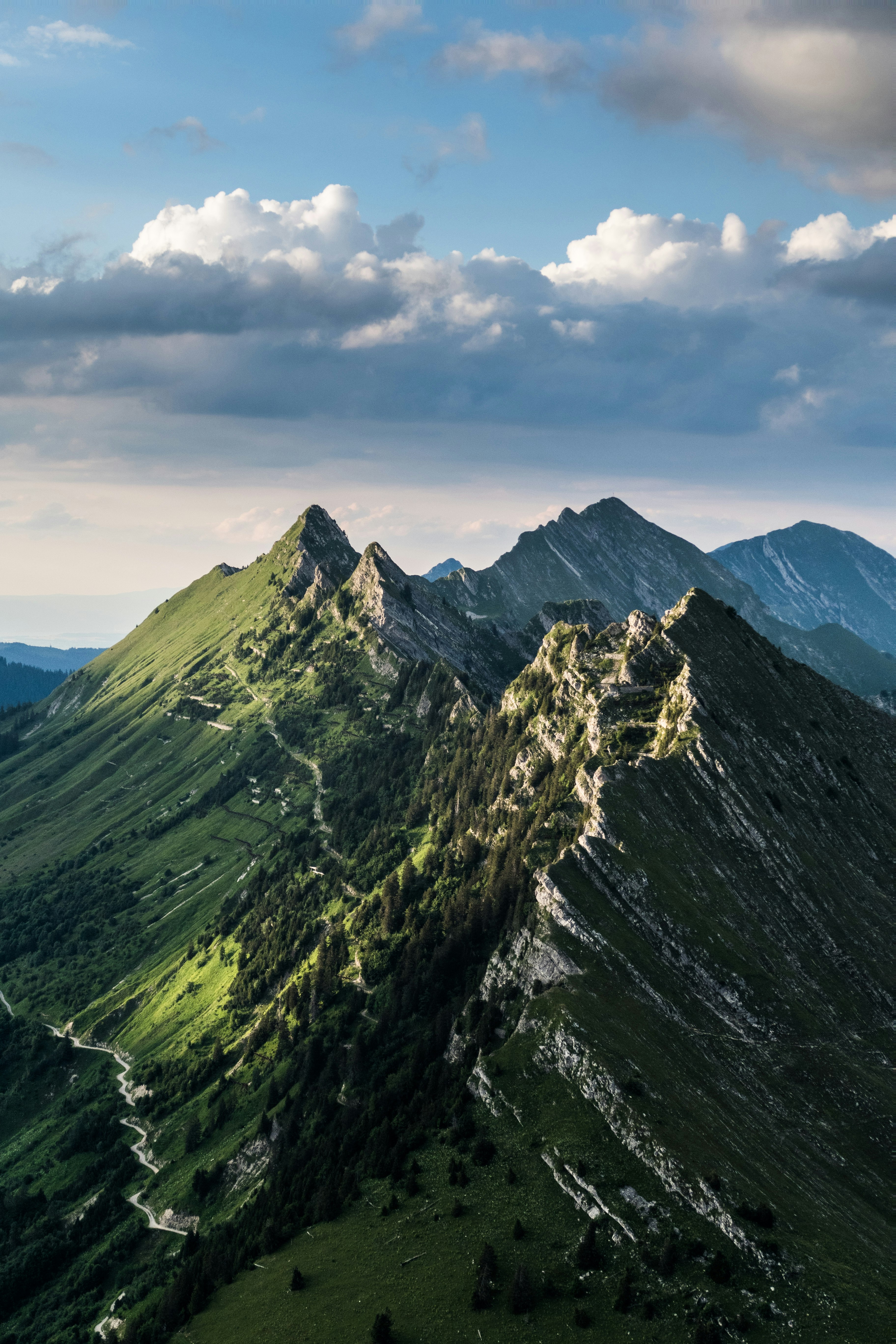 green and gray mountain under white clouds during daytime